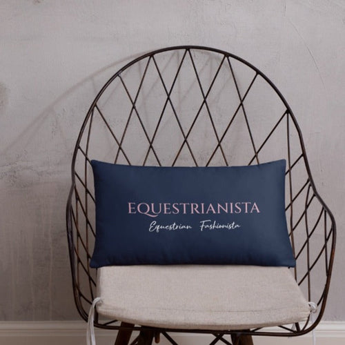 EQUESTRIANISTA Equestrian Fashionista phrase on small navy decorative pillow on a chair.