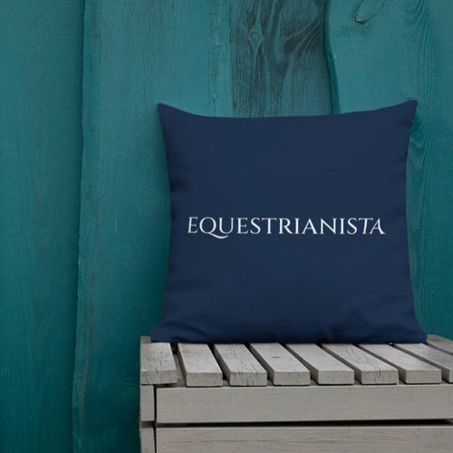 EQUESTRIANISTA Brand Navy Decorative Pillow on wooden bench.